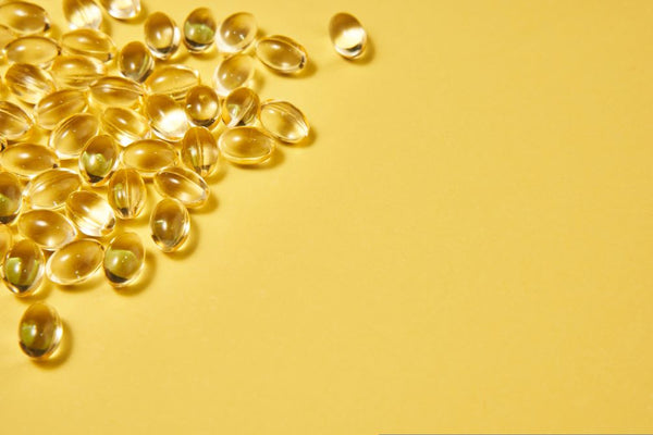 vitamin d3 supplements with a yellow background