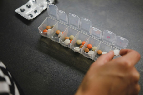 pill organizer filled with various vitamins and supplements