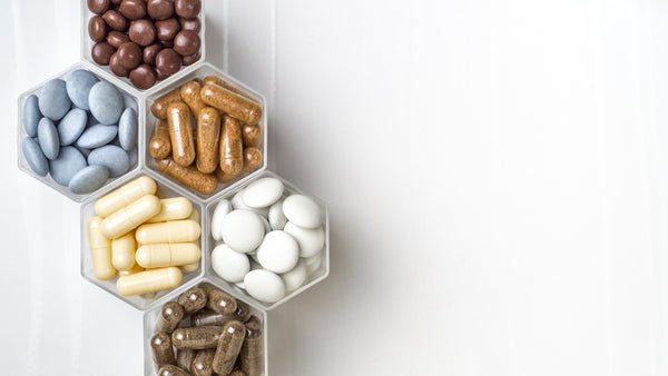 Various capsules and pills with dietary supplements or medicines in hexagonal jars are in the form of a honeycomb