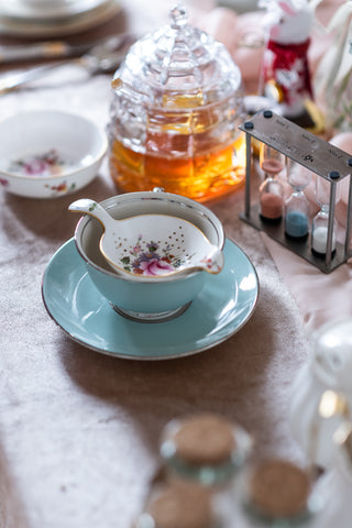 Porcelain tea cup, sauce & strainer with crystal honey jar