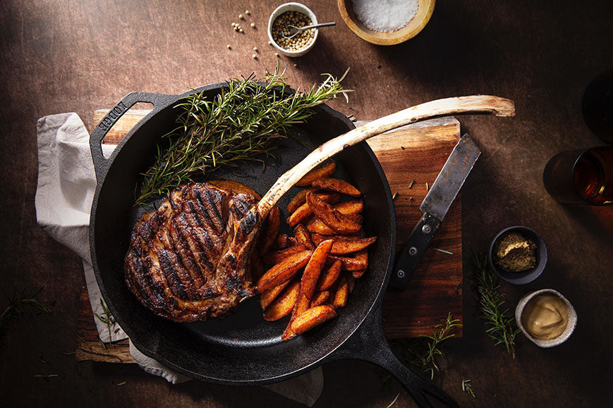 banner-image-2-iron-skillet-with-meat-and-potatoes-on-wooden-board