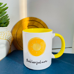 cute ceramic coffee mug in pastel yellow colour Think Less Feel More by posh the studio