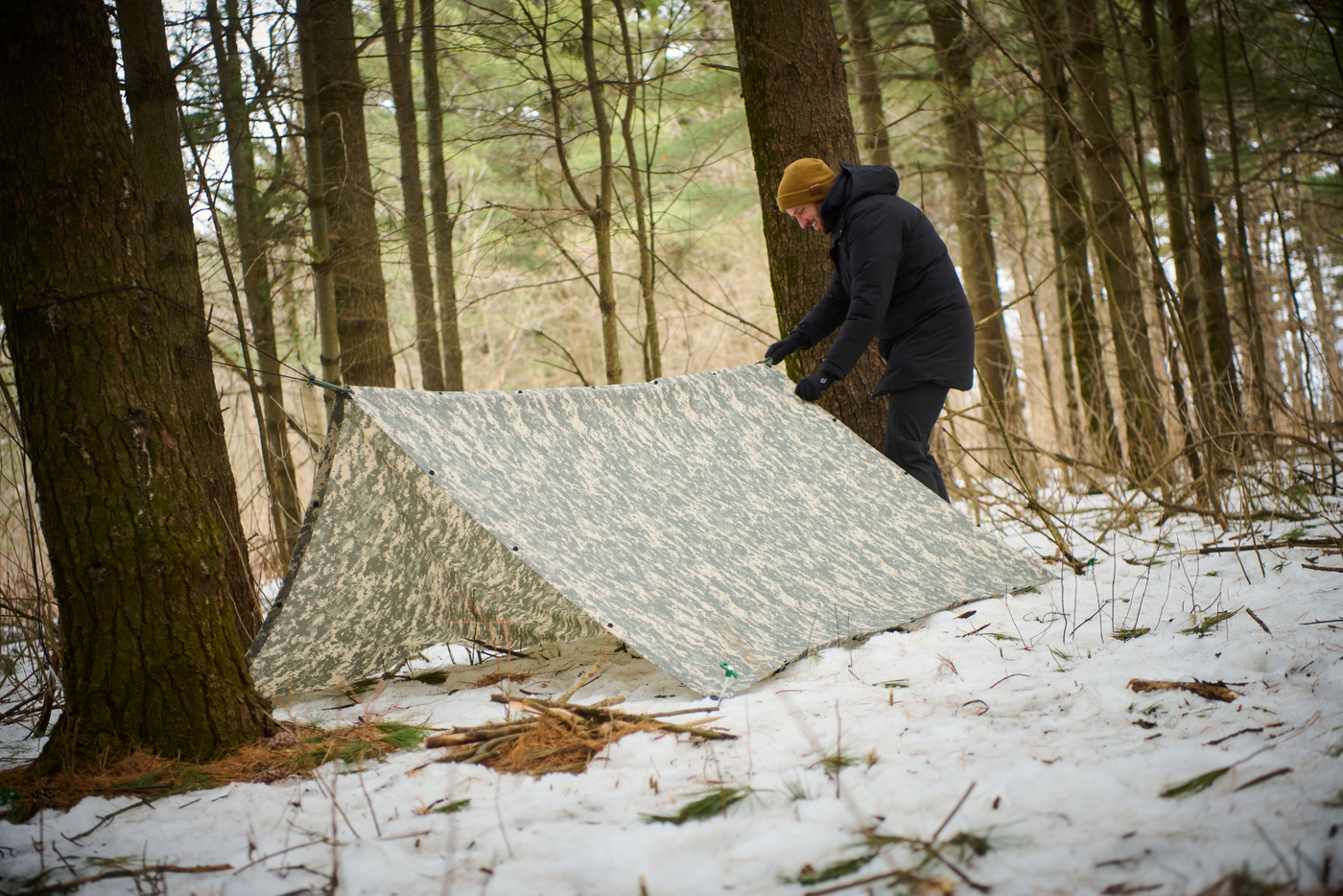 Person Tying Up A Military Grade Tarp