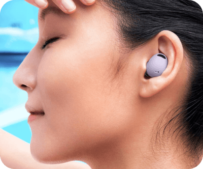 Person wearing pink Samsung ear bud next to a pool