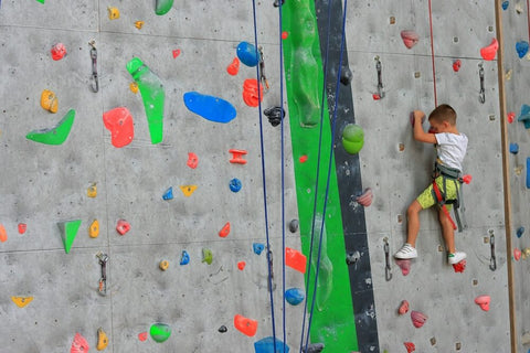 Child doing indoor rock climbing. Photo by Gabriel Vasiliu.