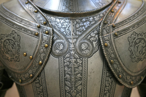 An ornate chest armor piece in a suit of armor. 