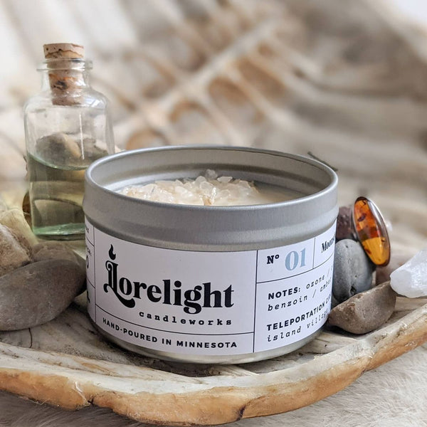 A soy candle in a metal tin. The label reads "Lorelight candleworks. Hand-poured in Minnesota"