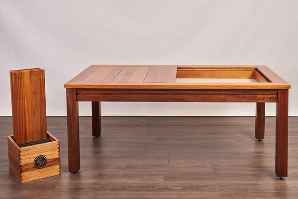 The Rustic style gaming table from Uniquely Geek in mahogany. Three of the leaves are in the table and the other three are in a holder on the floor.