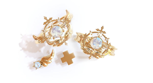 Two gold healer rings paired with a plus sign gold earring and winged earring by Bisoulovely.