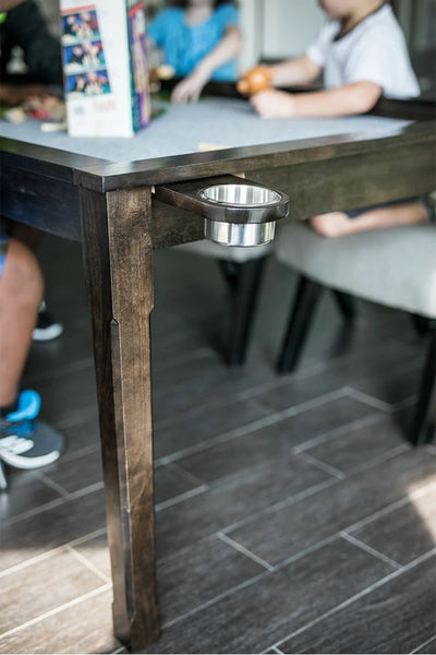 A close up of the Jasper table demonstrating a cup holder attached to a rail system.