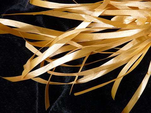 Strips of golden paper that resemble feathers