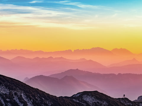 A colorful sunrise made up of pinks, yellows, and blue