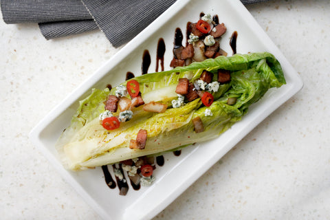 Grilled Romaine Salad Served on a White Plate