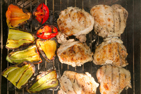 Grilled bell peppers with chicken on a charcoal grill