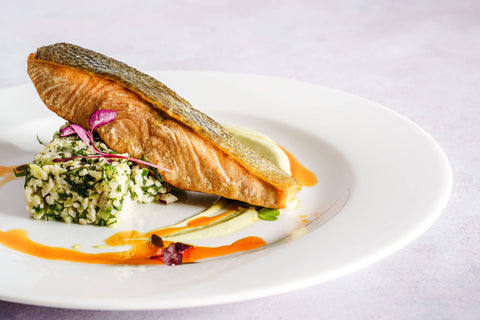 Grilled salmon served on a white ceramic plate