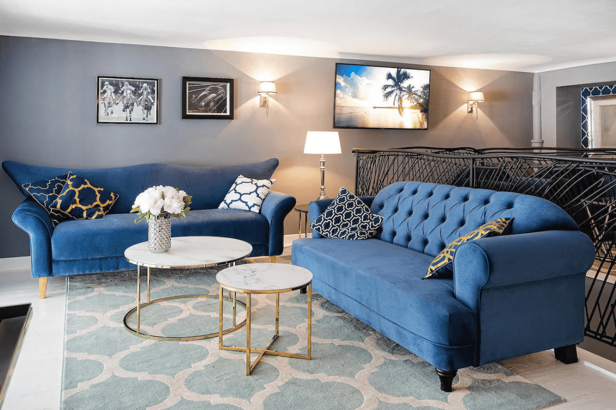 Blue Chesterfield sofas and a coffee table