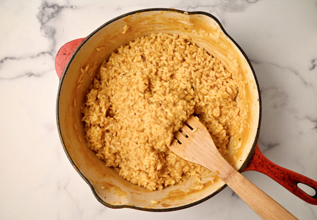 An above view of pumpkin risotto in a big pot