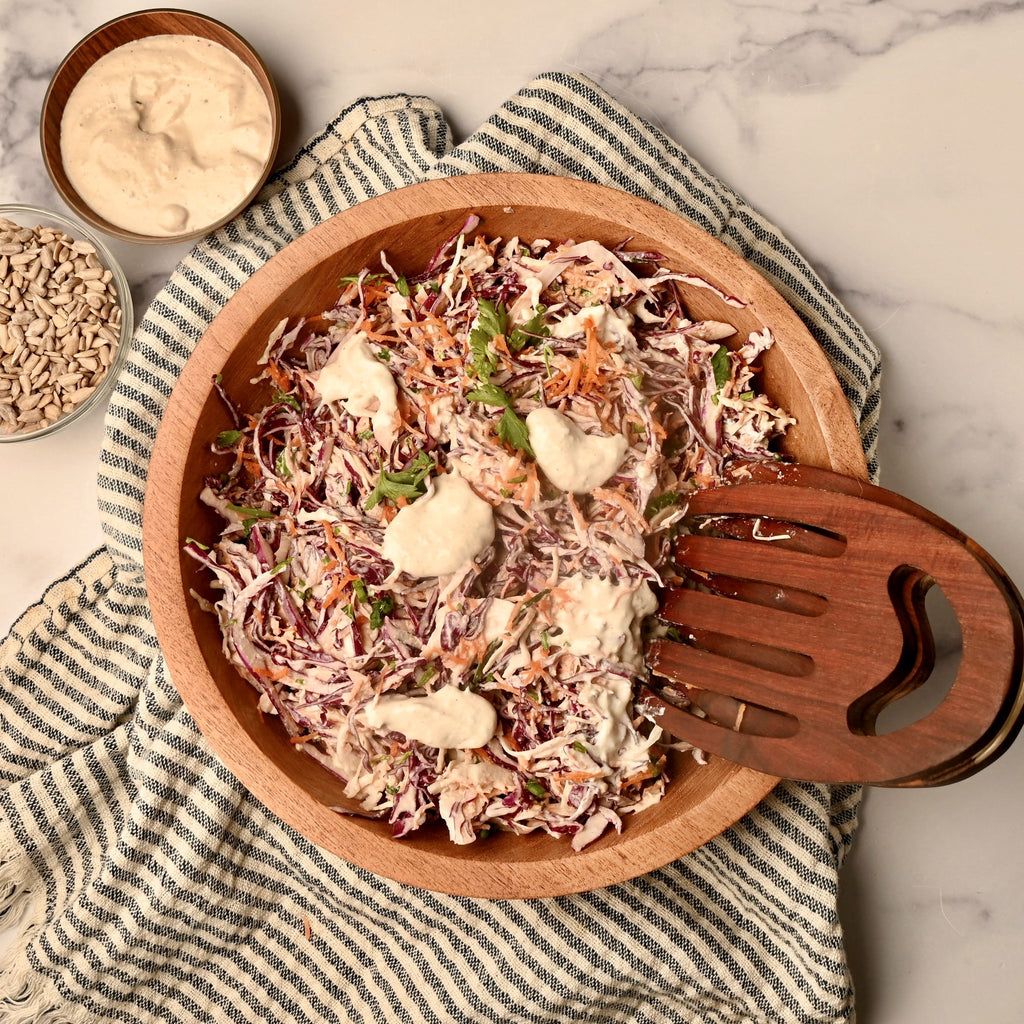 An overview of a big wooden bowl filled with homemade coleslaw
