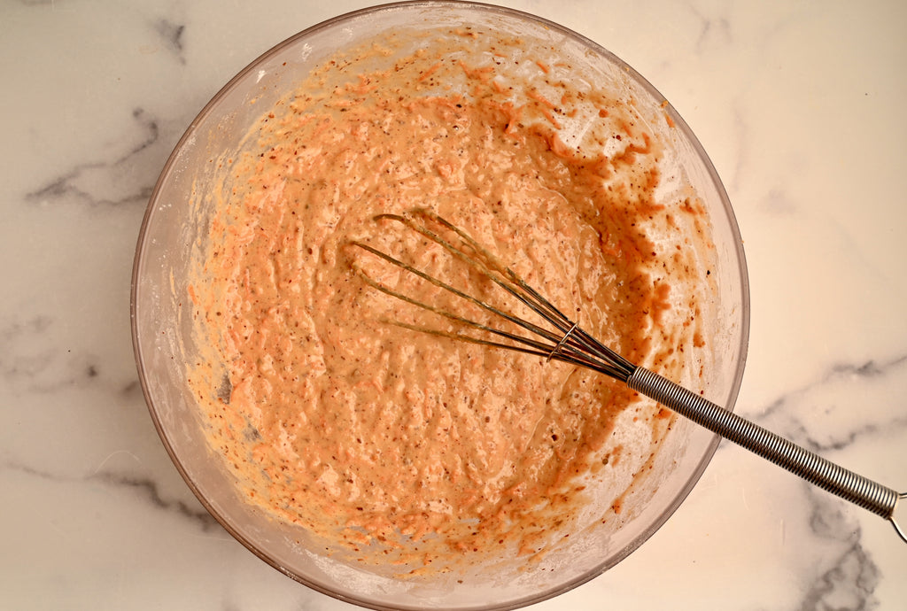 A bowl of raw carrot cake pancake batter