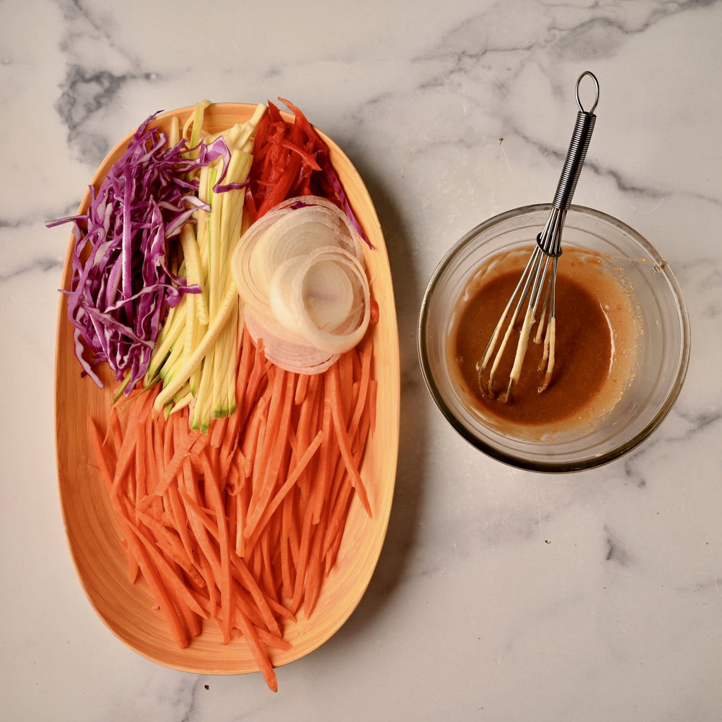 A wooden board with raw vegetables