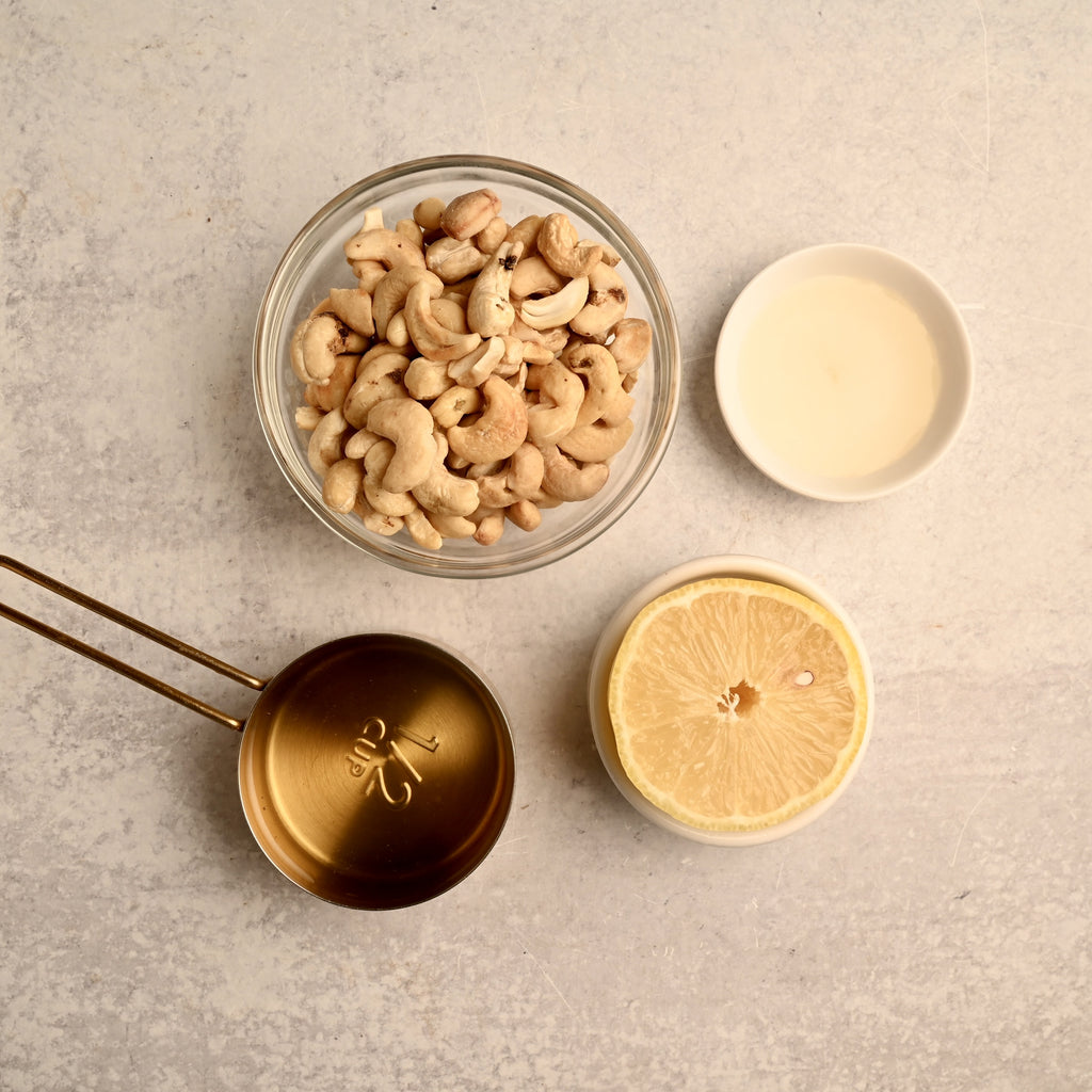 Raw cashews in a clear glass bowl