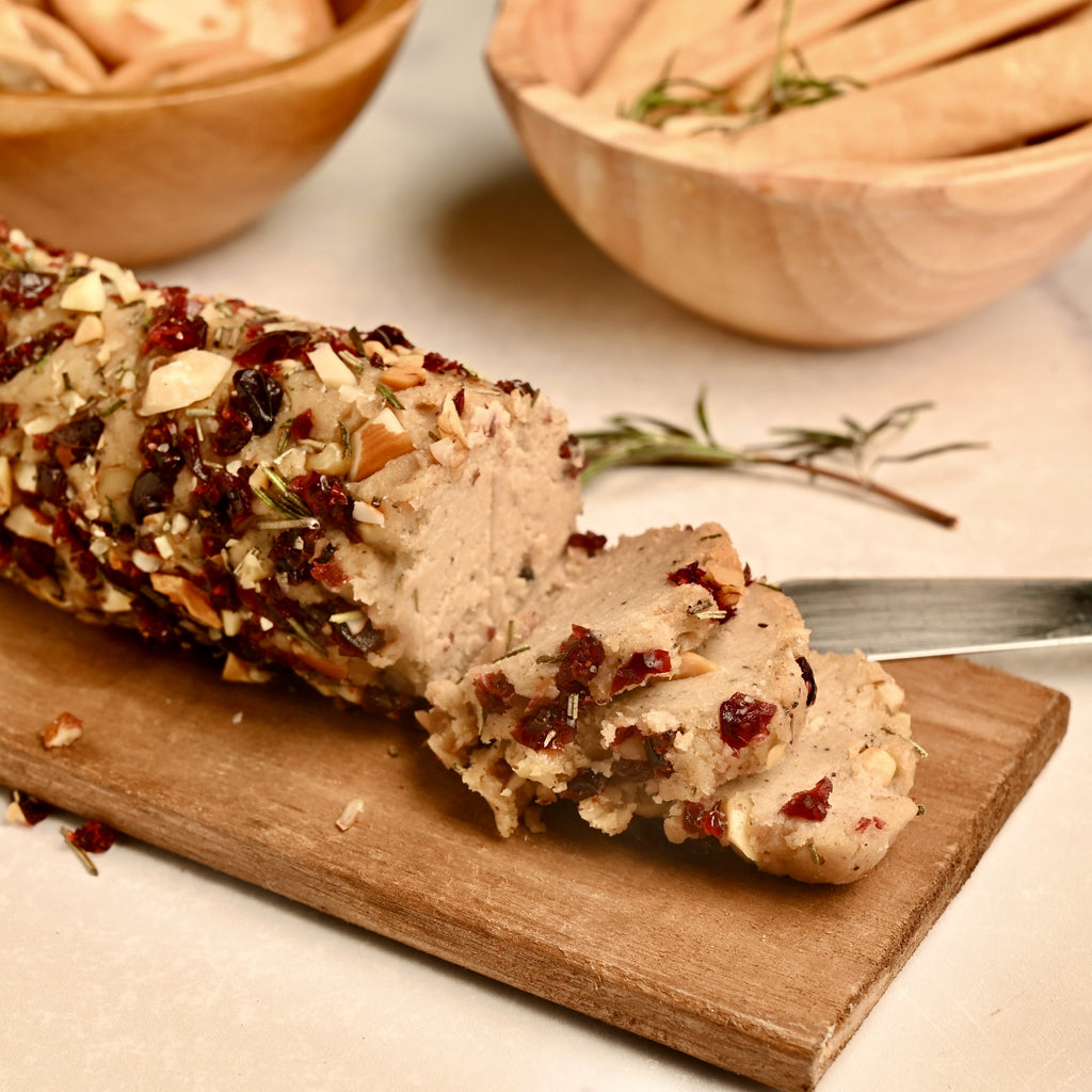 A close up of a cashew based cheese log