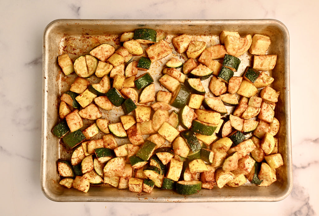 Diced zucchini on a roasting pan sheet