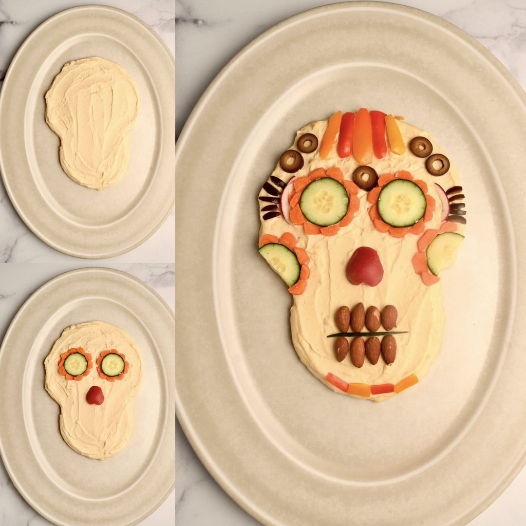 A plate with hummus on it in the shape of a skull
