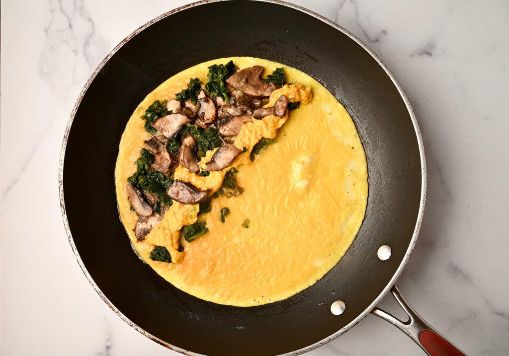 Omelette being made in a cast iron skillet