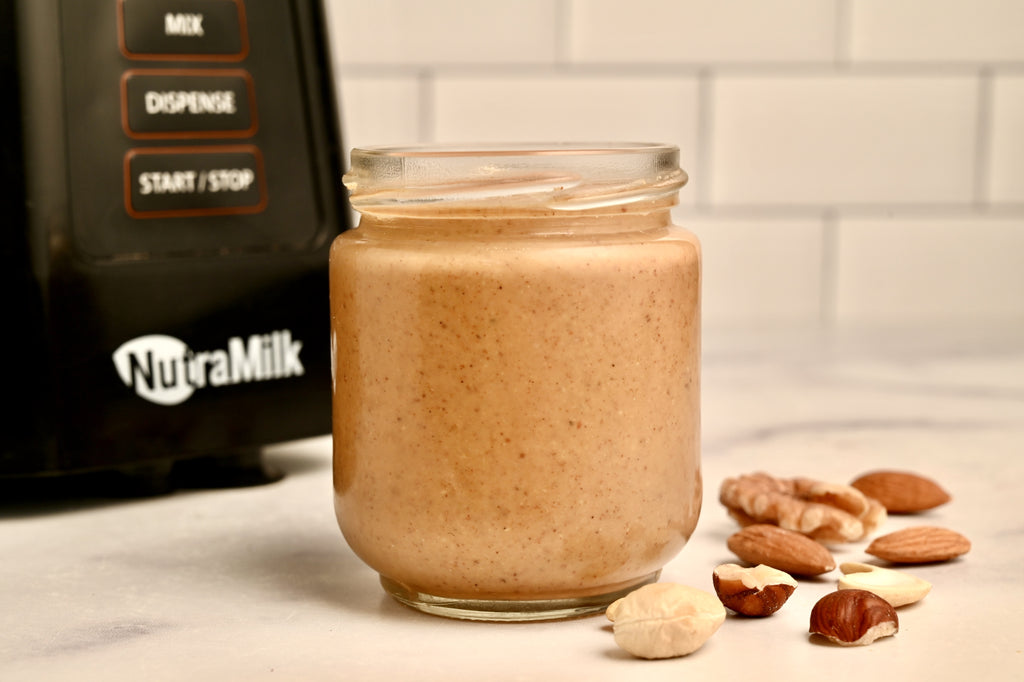 A jar of nut butter in front of The NutraMilk