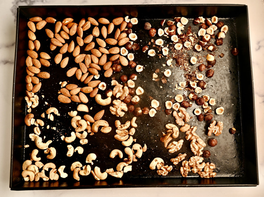 A baking tray covered in raw nuts