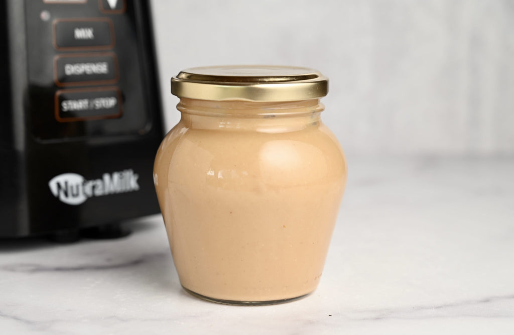 A jar of homemade peanut butter made using The NutraMilk