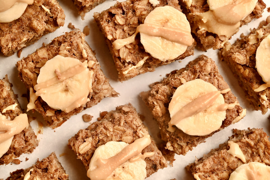 A close up of baked banana oatmeal squares