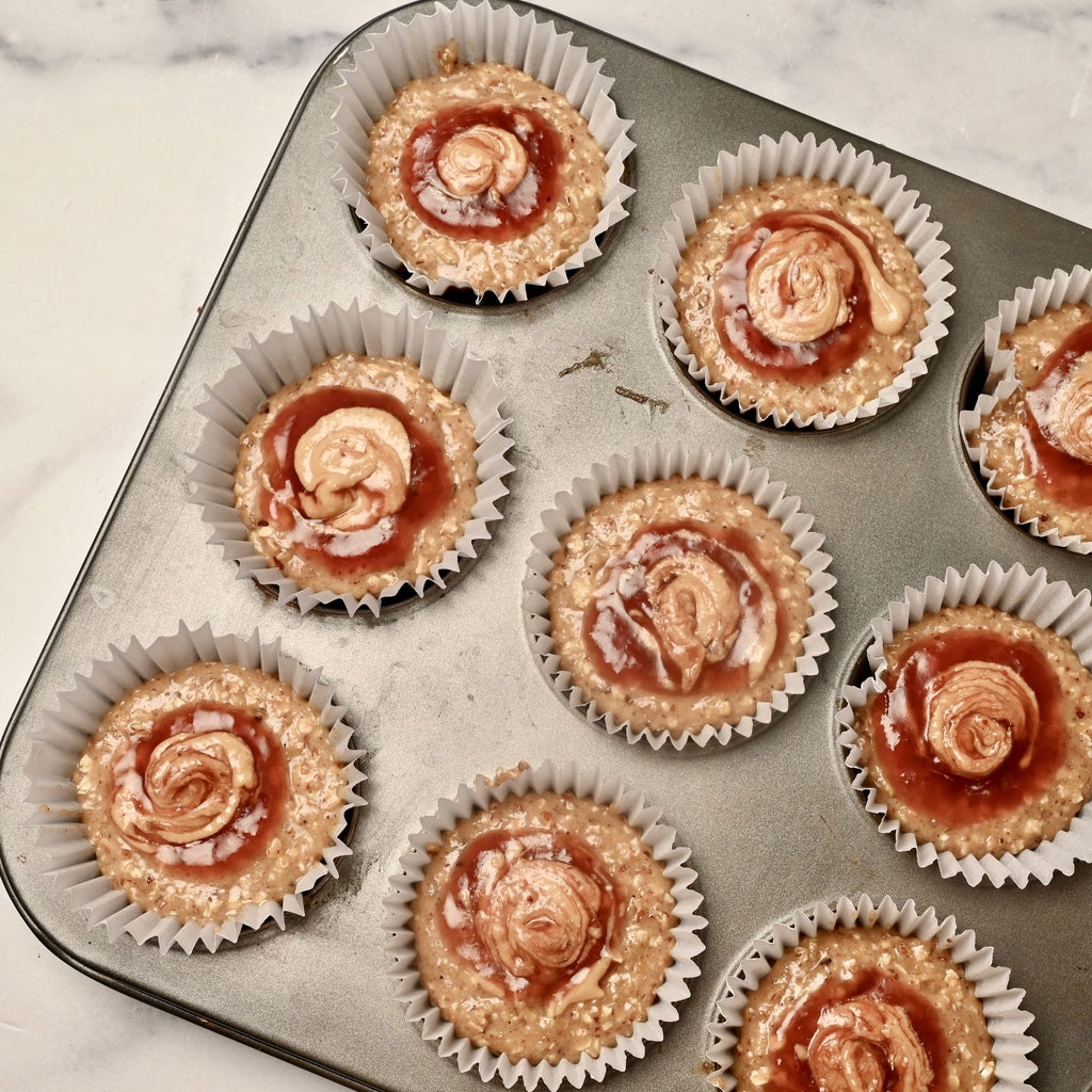 An overview of muffin trays filled with raw muffin mix