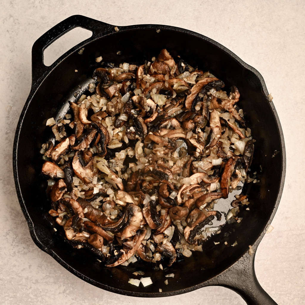 Cooked mushrooms in a black cast iron skillet