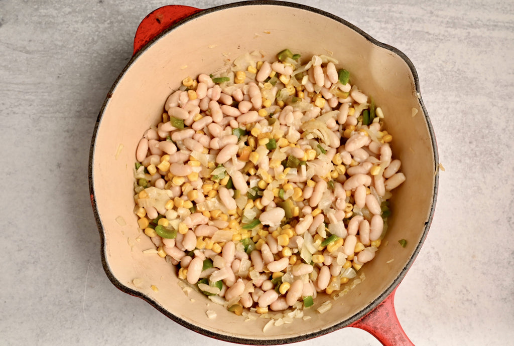 A close up of raw white beans in a big bowl