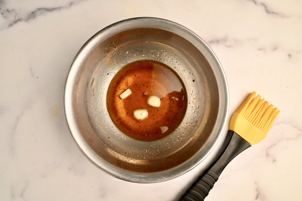 A mixing bowl with melted butter in it