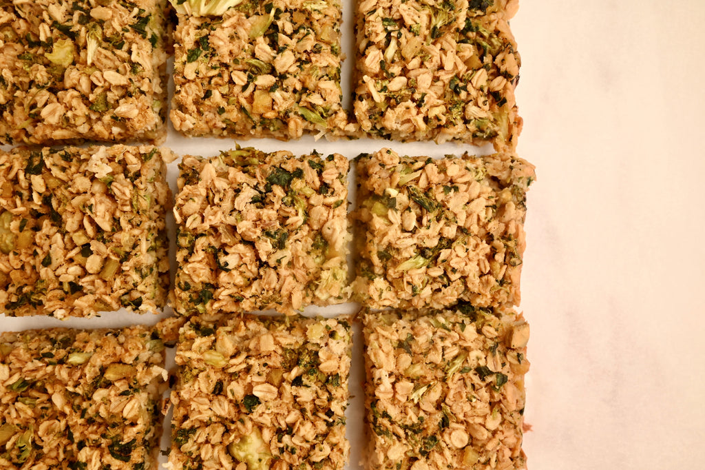 A baking sheet filled with cooked savory oatmeal veggie squares