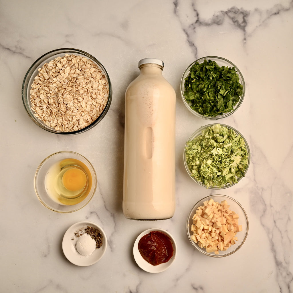 Raw oatmeal ingredients in clear glass bowls on a kitchen counter