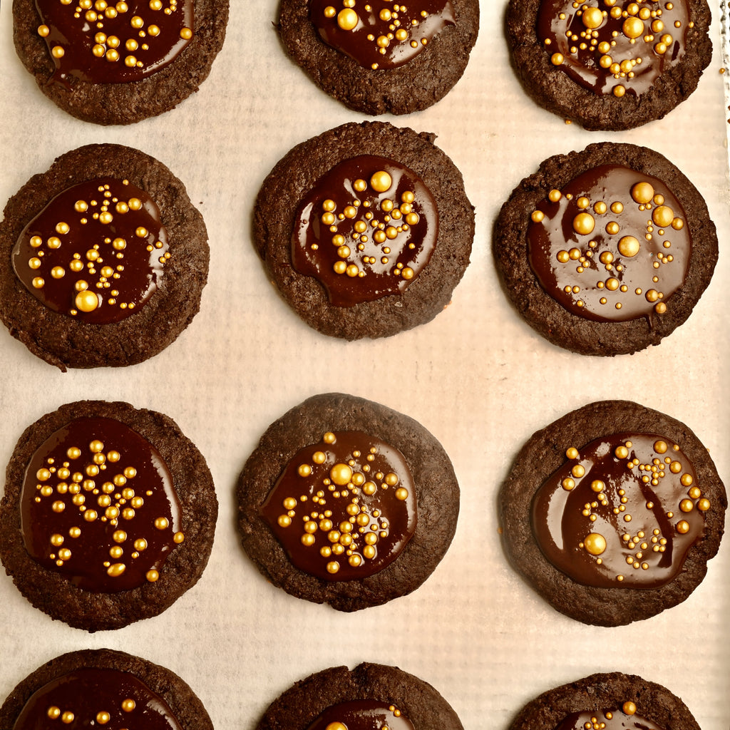 Double chocolate cookies with gold sprinkles in the center