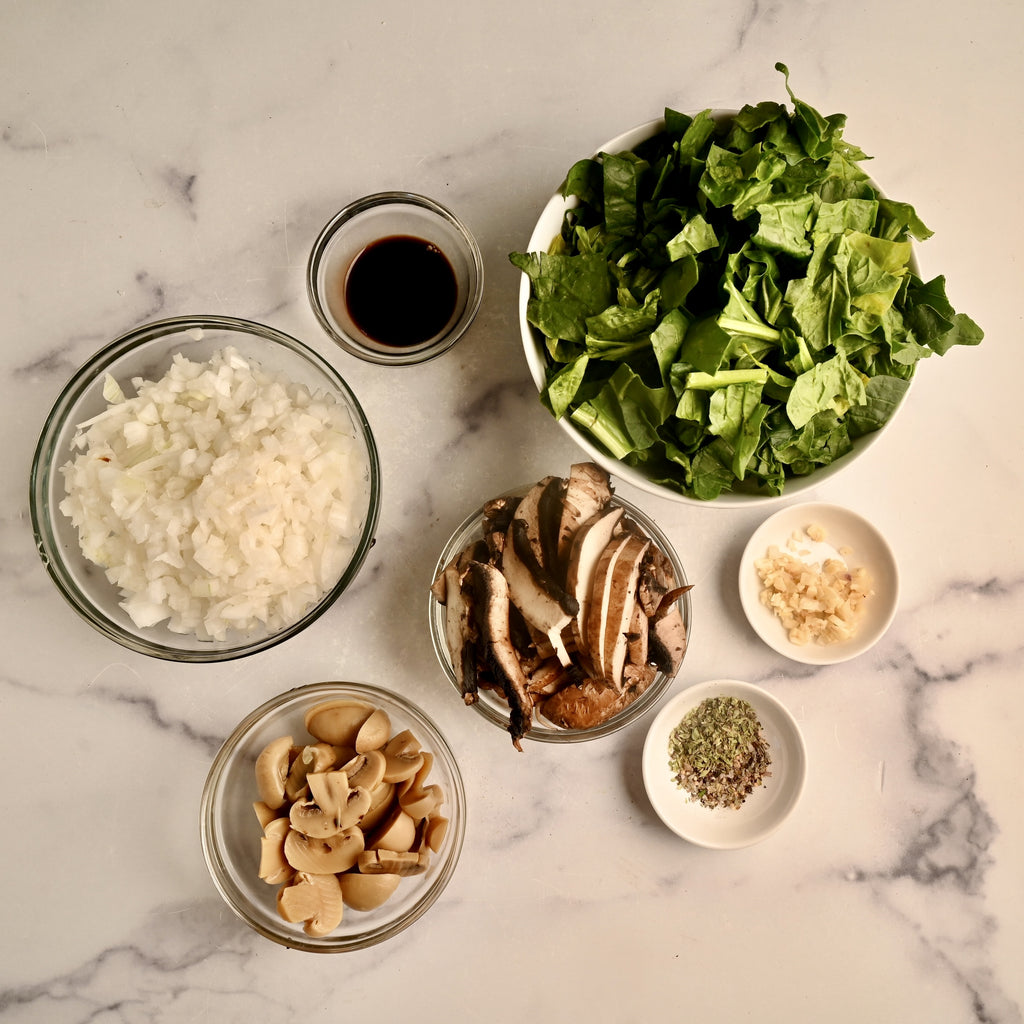 Raw ingredients in clear glass bowls on a kitchen countertop