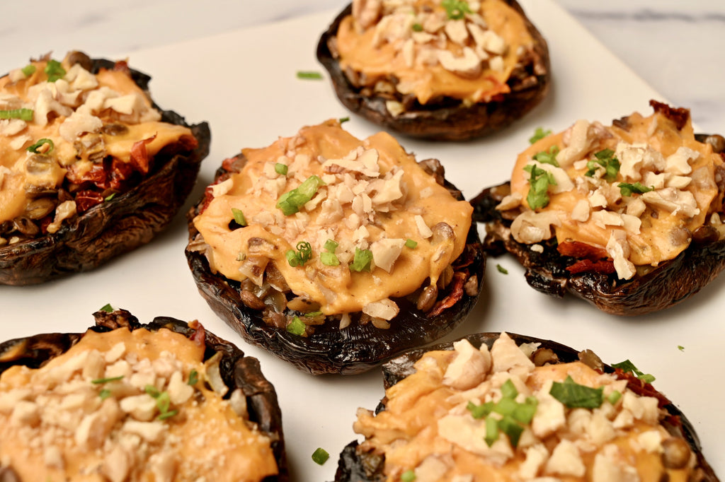 A close up of a plate of stuffed portobello mushrooms