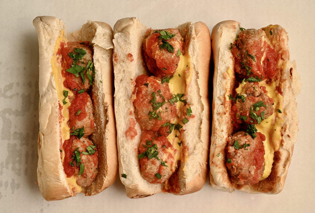 An overhead view of one meatball sandwich on a plate