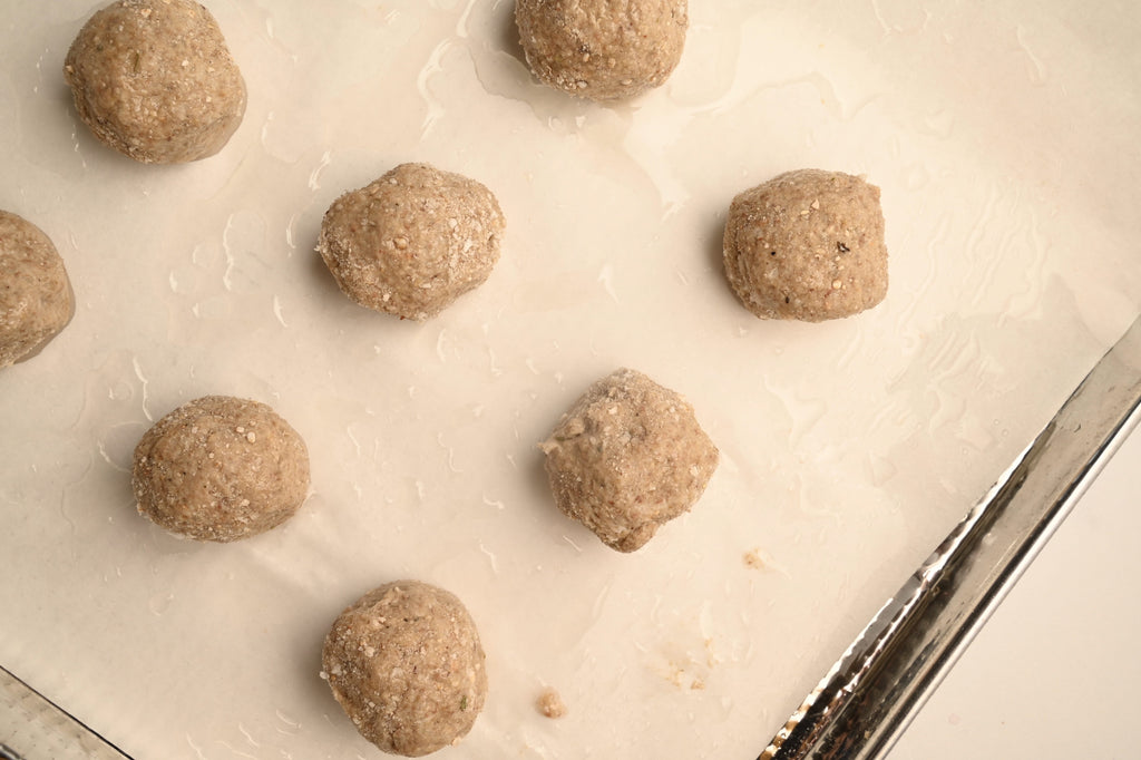 Individual plant-based meatballs on a tray