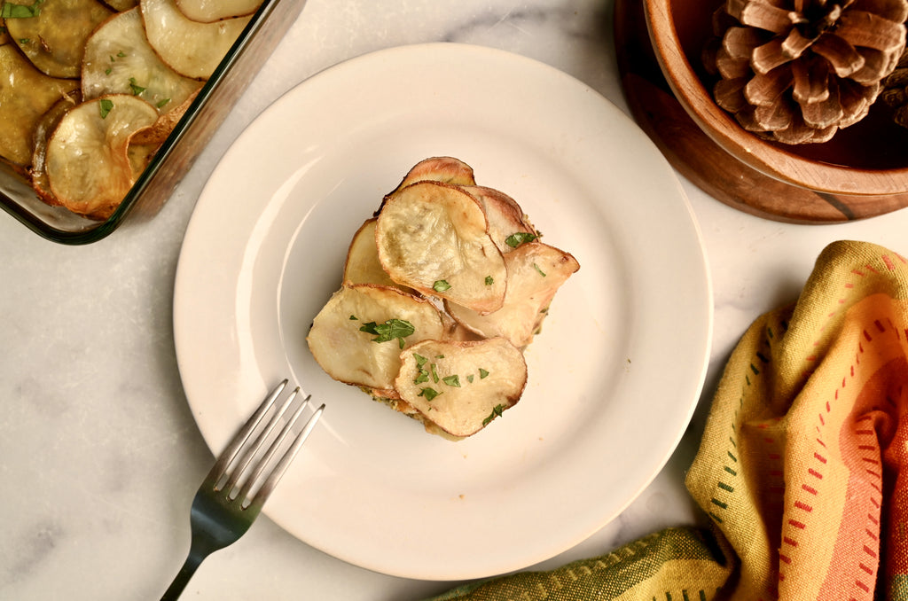 A slice of vegetable pot pie on a white ceramic plate with a fork off to the side