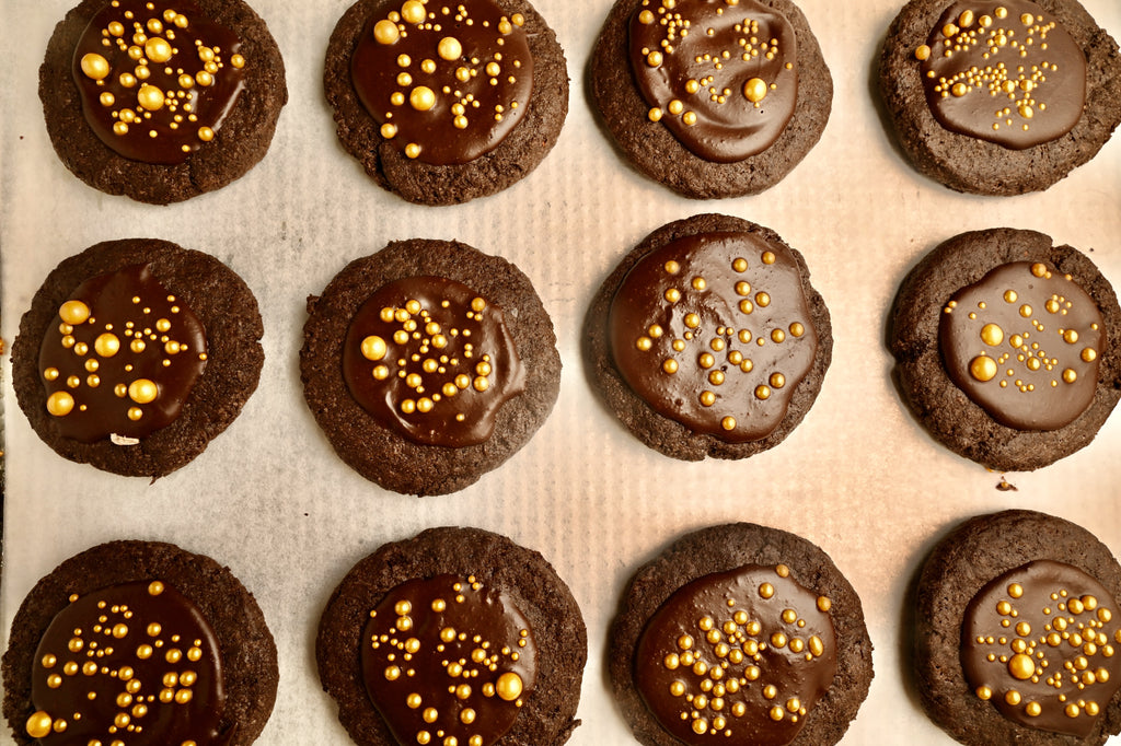 Baked double chocolate cookies with gold sprinkles in the middle