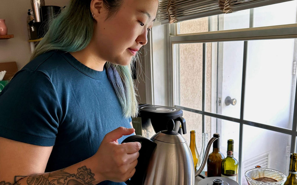 Mar is using the Bonavita kettle in making pour over coffee in a kitchen.