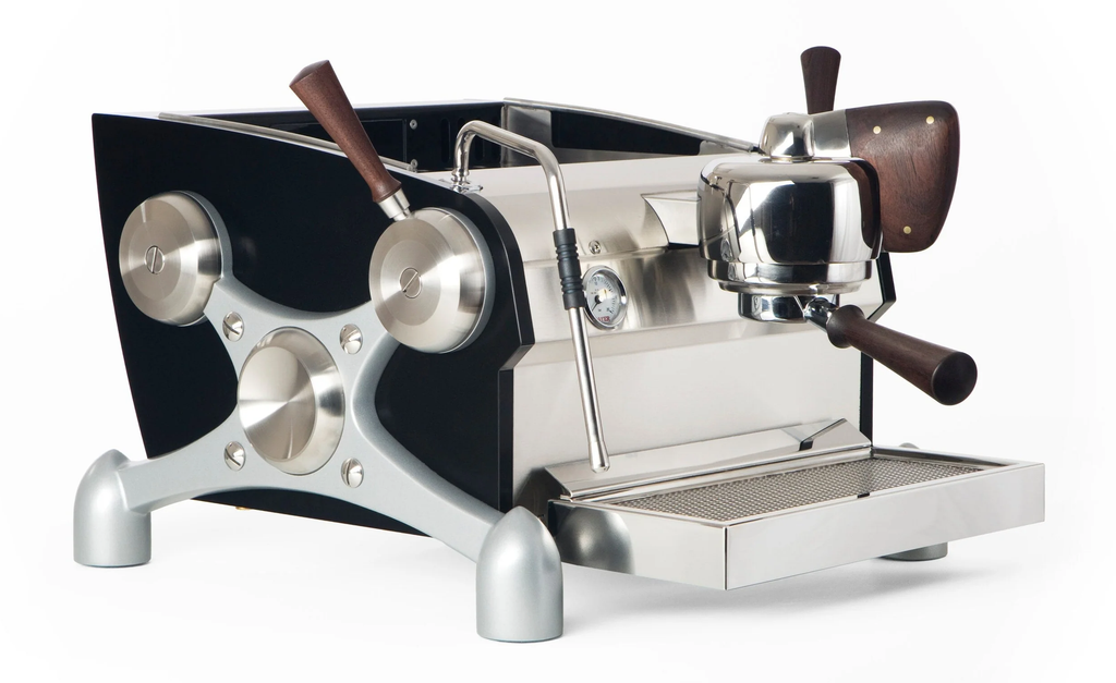 A Slayer Single Group home espresso machine with walnut wood accents.