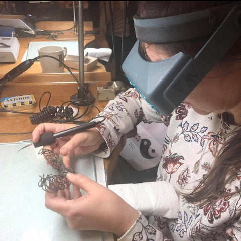 Sandrine B. working on the fishing net necklace