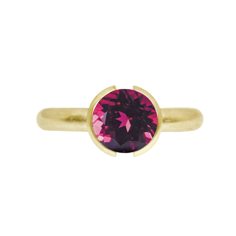 open bezel ring with a rhodolite garnet